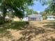 The backyard has some shade trees and a screened in enclosure at 1625 Normandy Way, Leesburg, FL 34748