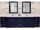 Bathroom vanity featuring double sinks, quartz countertop, navy blue cabinets and gold hardware at 2260 Mulbry Dr, Winter Park, FL 32789