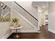 Foyer with dark wood floors, staircase with black wrought iron railing, and stylish decor at 2260 Mulbry Dr, Winter Park, FL 32789