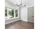 A room with hardwood floors, large windows, modern lighting fixture, and light gray doors at 2260 Mulbry Dr, Winter Park, FL 32789
