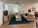 Comfortable living room features stylish furniture, a ceiling fan, and tasteful decor at 2325 Crossandra St, Mascotte, FL 34753
