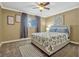 Comfortable bedroom featuring neutral walls, patterned bedding and window with curtains at 320 Lakeview St # 123, Orlando, FL 32804