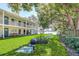 Exterior view of condos with lawn and lake views featuring BBQ and picnic tables at 320 Lakeview St # 123, Orlando, FL 32804