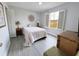 Cozy bedroom with a queen bed, nightstands, and a view from a large window at 3602 Calabria Ave, Davenport, FL 33897