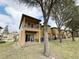 Tan two story townhome with private balcony and fenced backyard at 3602 Calabria Ave, Davenport, FL 33897
