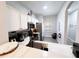 Open kitchen with white cabinets and stainless steel appliances at 3602 Calabria Ave, Davenport, FL 33897