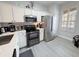 Modern kitchen with stainless steel appliances and white cabinets at 3602 Calabria Ave, Davenport, FL 33897