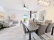 Open living and dining area with gray furniture and wood-look floors at 3602 Calabria Ave, Davenport, FL 33897