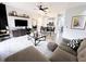Modern living room features an L-shaped sectional sofa and large TV at 3602 Calabria Ave, Davenport, FL 33897