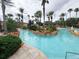Lazy river style pool with palm trees at 3602 Calabria Ave, Davenport, FL 33897
