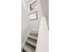 Modern staircase with wood-look flooring and a large window at 3602 Calabria Ave, Davenport, FL 33897