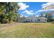 Rear view of house with two-car garage and spacious backyard at 3690 Se 115Th St, Belleview, FL 34420