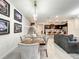Open-concept dining area flows into the kitchen, featuring modern lighting and neutral decor at 4190 Lana Ave, Davenport, FL 33897