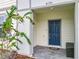 Charming home featuring a blue front door, covered entryway, and neatly landscaped surroundings at 4190 Lana Ave, Davenport, FL 33897