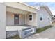 Inviting front porch with neutral siding, and classic design, perfect for enjoying neighborhood views at 550 N Ridgewood Ave, Daytona Beach, FL 32114