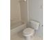 Bright bathroom featuring a toilet, tile flooring, and a bathtub at 5542 Metrowest Blvd # 206, Orlando, FL 32811