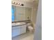 Bathroom with a large mirror, and white tile, with vanity sink at 5542 Metrowest Blvd # 206, Orlando, FL 32811