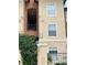 Apartment complex exterior featuring neutral tones and gated entrance with green foliage at 5542 Metrowest Blvd # 206, Orlando, FL 32811