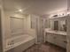 Main bathroom with a tub, shower and updated vanity at 713 Swan Way, Kissimmee, FL 34758