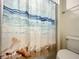 Bathroom with seashell shower curtain at 826 Paradise Dr, Davenport, FL 33897