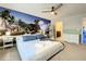 Main bedroom with a tropical mural and ensuite bathroom at 826 Paradise Dr, Davenport, FL 33897