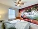 Bedroom featuring a ceiling fan and a scenic waterfall mural as a backdrop at 826 Paradise Dr, Davenport, FL 33897