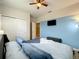 Spacious bedroom with a comfortable bed and mounted TV at 826 Paradise Dr, Davenport, FL 33897