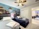 bedroom features a ceiling fan and an ocean mural with a playful sea life theme at 826 Paradise Dr, Davenport, FL 33897