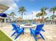 Relaxing fire pit area with blue Adirondack chairs and patio at 826 Paradise Dr, Davenport, FL 33897