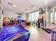 Fun game room featuring air hockey, basketball game, and various arcade games at 826 Paradise Dr, Davenport, FL 33897
