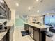 Modern kitchen with island, dark cabinets, granite countertops, and stainless steel appliances at 826 Paradise Dr, Davenport, FL 33897