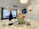 Granite kitchen island with wine, water, and snacks at 826 Paradise Dr, Davenport, FL 33897