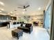Open living room with black couch, ottoman, and view of the pool at 826 Paradise Dr, Davenport, FL 33897
