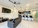 Open living room with black couch, ottoman, and ceiling fan at 826 Paradise Dr, Davenport, FL 33897