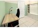 Small home office with light wood desk, black chair, and built-in shelving at 826 Paradise Dr, Davenport, FL 33897