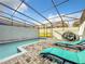 Private pool with lounge chairs and screened enclosure at 826 Paradise Dr, Davenport, FL 33897