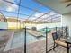 Private screened pool with lounge chairs and dining area at 826 Paradise Dr, Davenport, FL 33897