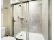 Modern shower with glass doors, sleek fixtures, and neutral tile at 826 Paradise Dr, Davenport, FL 33897