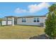 Spacious backyard with a covered patio and sliding glass door at 1124 Griffon Ave, Lake Alfred, FL 33850