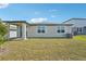 Spacious backyard with a covered patio and sliding glass door at 1124 Griffon Ave, Lake Alfred, FL 33850