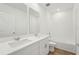 Bathroom with a double sink vanity featuring wood-look tile floors and bathtub with shower at 1124 Griffon Ave, Lake Alfred, FL 33850