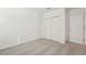 Bedroom featuring neutral carpeting, white walls and a double door closet at 1124 Griffon Ave, Lake Alfred, FL 33850