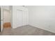 Bedroom featuring neutral carpeting, white walls and a large closet for ample storage at 1124 Griffon Ave, Lake Alfred, FL 33850