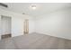 Bedroom featuring neutral carpeting, white walls and an adjoining closet and bathroom at 1124 Griffon Ave, Lake Alfred, FL 33850