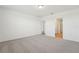 Bright bedroom featuring neutral carpeting, white walls and access to an adjoining bathroom at 1124 Griffon Ave, Lake Alfred, FL 33850