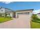 Well maintained single-story home with a brick-paved driveway, two-car garage and beautifully landscaped front yard at 1124 Griffon Ave, Lake Alfred, FL 33850