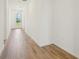 Inviting hallway featuring stylish wood-look floors and an exterior door with neighborhood views at 1124 Griffon Ave, Lake Alfred, FL 33850