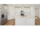 Modern kitchen with stainless steel appliances, a large island, and white cabinetry at 1124 Griffon Ave, Lake Alfred, FL 33850