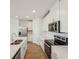Modern kitchen featuring stainless appliances and sleek white cabinetry at 1124 Griffon Ave, Lake Alfred, FL 33850