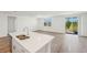 Bright, open-concept living area with center island, tile floors, and natural light at 1124 Griffon Ave, Lake Alfred, FL 33850